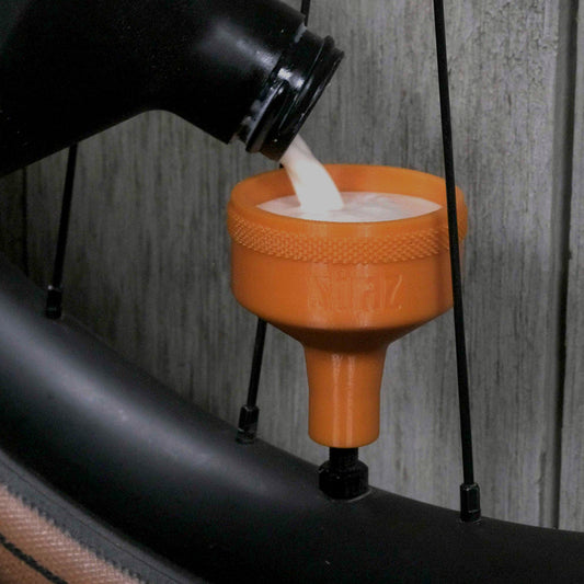 Sealant Funnel for filling tubeless bicycle tires with tire sealant.  Alternative to tire sealant injector.